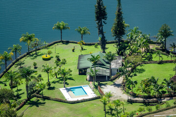 Closeup look of a house near the hydroelectric reservoir and lakes of El Peñol de Guatape, in Medellin, Colombia.