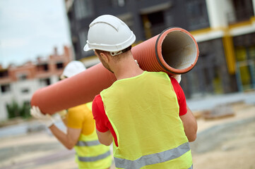 Two loaders in hardhats working on the construction site