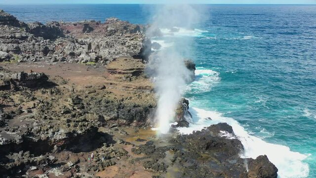 Waves crash against Maui's cliffs