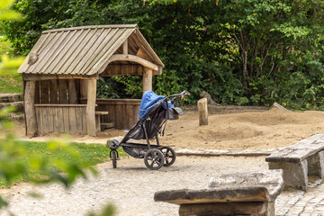 A lone baby buggy on a playground