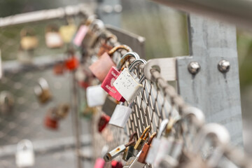 Padlocks on a fence. Locks applied by couples in love on a fence.