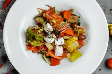 Greek salad with fresh vegetables, feta cheese and black olives