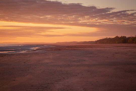 Sunrise over the horizon over the sea at the beach in Darwin, Northern Territory, Australia © Julia