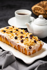 English cake topped with fondant, raisins and walnuts.