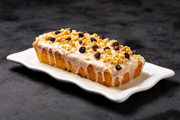 English cake topped with fondant, raisins and walnuts.