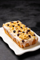 English cake topped with fondant, raisins and walnuts.