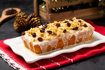 English cake topped with fondant, raisins and walnuts.
