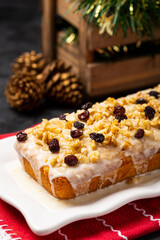 English cake topped with fondant, raisins and walnuts.
