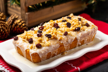 English cake topped with fondant, raisins and walnuts.