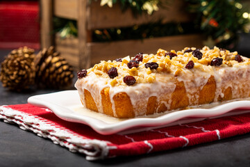 English cake topped with fondant, raisins and walnuts.