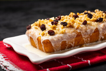 English cake topped with fondant, raisins and walnuts.