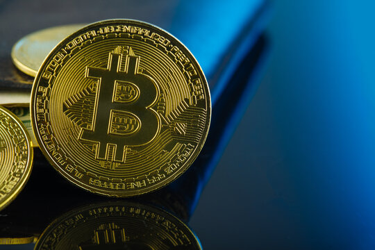Bitcoins on a beautiful blue background. Minimalism. Close-up. There are no people in the photo. Economy, finance, cryptocurrency. Electronic business, bidding.