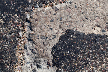 a bad road with poorly repaired potholes and pits