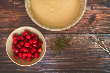 Preparation of cherry pie - flat lay view of cherries and yeast dough before baking. 