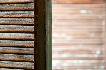 Green wooden shutters. Background with textured narrow boards in green. Old green wooden shutters.