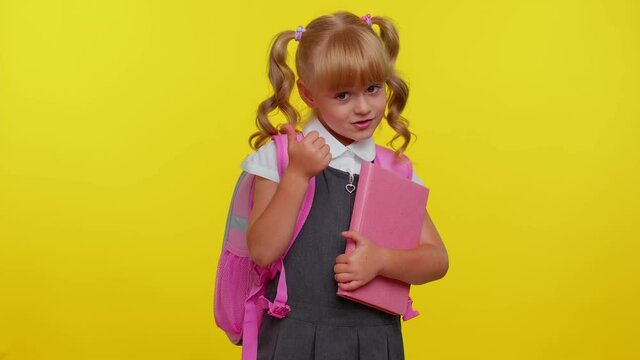 I am the best. Happy satisfied selfish haughty kid school girl proud of her victory, bragging own success win achievements, pointing with smile fingers on herself on yellow background. Back to school