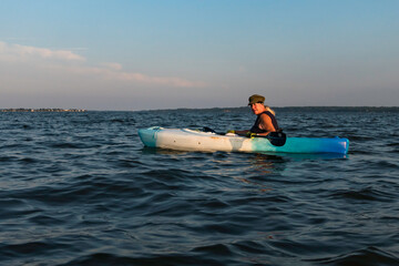 Solomons Maryland USA, Aug 6, 2021 A woman kayaks in the Patuxent river.