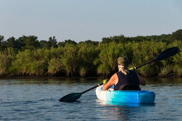 Solomons Maryland USA, Aug 6, 2021 A woman kayaks in the Patuxent river.