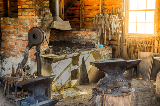 An old colonial Blacksmith shop at sunrise as the sunlight flows through a window