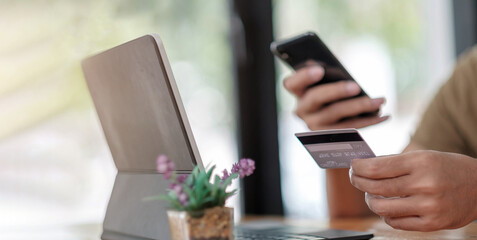 Man enjoy with online shopping application and typing credit card for fill number to payment