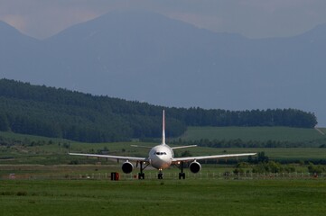 Airliner in representative Hokkaido landscape