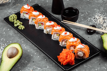Philadelphia roll sushi with salmon, smoked eel, cucumber, avocado, cream cheese, red caviar. Sushi menu. Japanese food