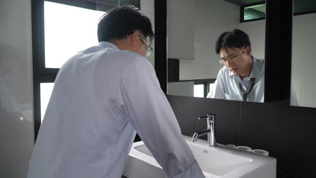 Unemployed Asian man standing in front of mirror screaming and blame himself mistake. Stressed businessman entrepreneur unsuccessful in business. Mental health and economic financial problem concept.