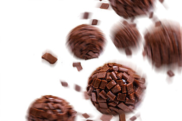 Brigadeiro, a traditional Brazilian candy made with chocolate with sprinkles spiral, on white...