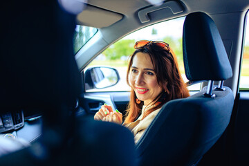 brunette middle age student woman in new car outdoor summer day