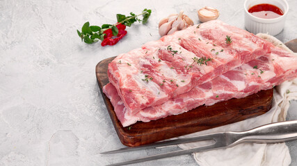Raw ribs on ligth gray background. Gourmet cooking food concept.