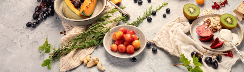 Fruit assortment served on light gray table.