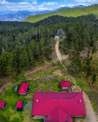 Vertical shot of red cottages in a forest in San Pedro De Macoris, the Dominican Republic
