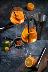 Aperol spritz cocktail served on dark background.