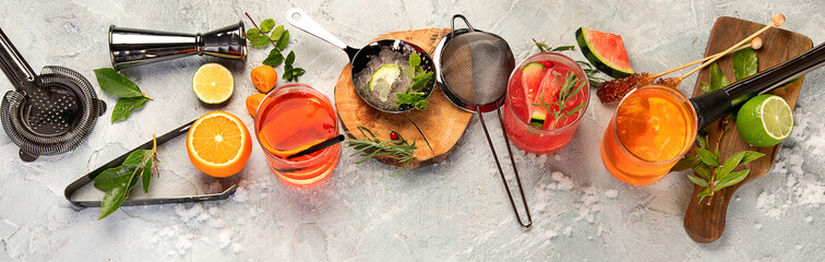 Cocktails assortment served on light background.