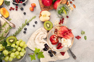 Fruit assortment served on light gray table.
