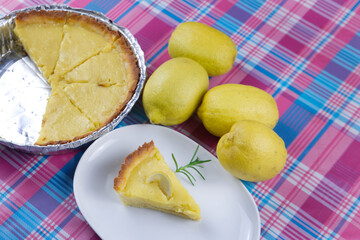 the piece of lemon curd tart  and  lemons 