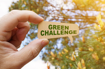 A man holds a sign inside which the inscription - Green challenge