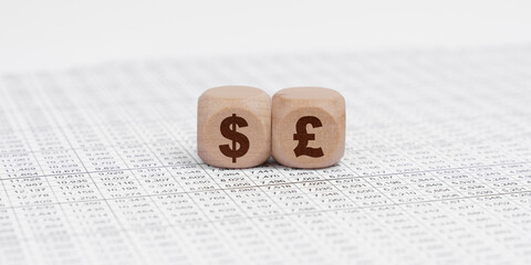 The accounting documents have cubes with dollar and pound sterling signs