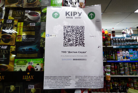 Kazakhstan, Ust-Kamenogorsk, august 2, 2021: Visitors to the shopping center scan the QR code to enter the building through the Ashyq system. Ashyq = Fascism. Modern fascism