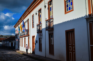 A person walking through the colonial streets of historic, world heritage-listed Diamantina town, Minas Gerais state, Brazil