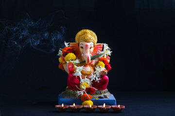 Decorative Lord ganesha sclupture on dark background.