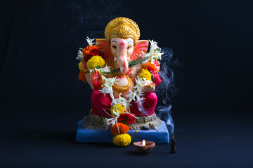 Decorative Lord ganesha sclupture on dark background.