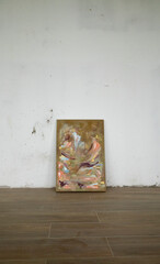 Contemporary art. Abstract multicolor painting, laying in the floor of the empty room. Beautiful brush texture and color pattern.