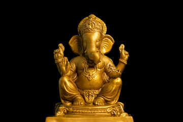 Golden lord ganesha sclupture over dark background. celebrate lord ganesha festival.