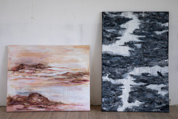 Modern art. View of two expressive paintings in the art studio. The paintings depict natural...