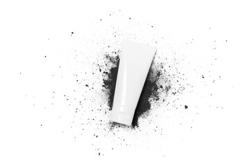Blank or empty cosmetic plastic tube with charcoal with charcoal powder background. Skin...