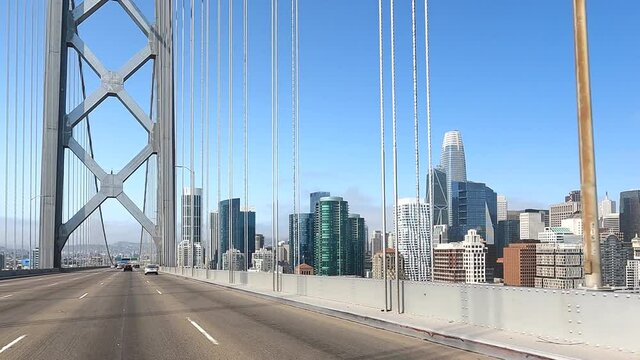 4K HD video Driving POV across the upper deck of the Bay Bridge into the city with minimal light traffic, city seen on right with smoke from wildfires settled into the marine layer.
