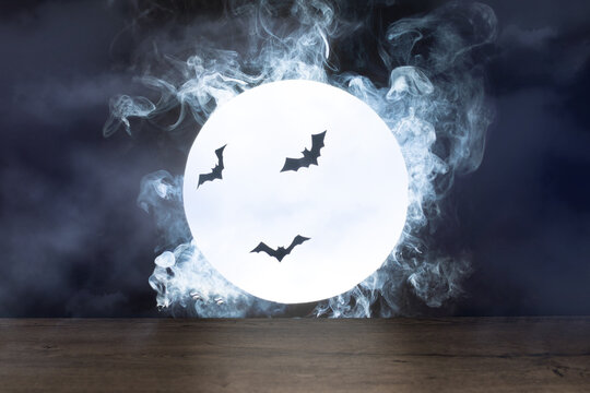 Halloween background. Spooky night with full moon and wooden table. Halloween scary night.