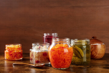Fototapeta na wymiar Fermented, probiotic food. Canned vegetables. Pickled carrot, sauerkraut and other organic preserves in mason jars. Healthy vegan cooking concept with a place for text