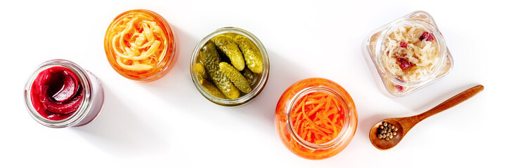Fermented food panorama on a white background. Canned vegetables. Pickles, sauerkraut and other organic preserves in glass jars. Healthy vegan cooking concept - obrazy, fototapety, plakaty